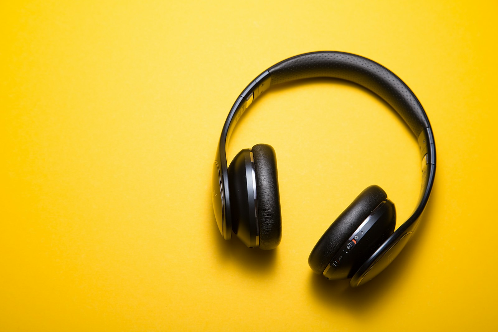 Black leather-pad headphones on yellow